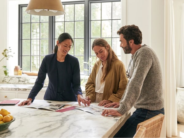 Aris360 Agent with two customers talking at a kitchen table